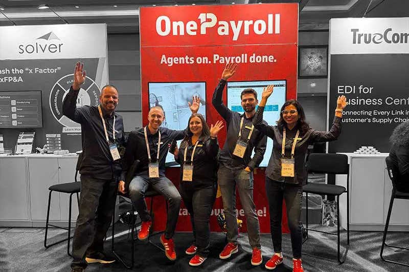 OnePayroll team in front of our expo booth
